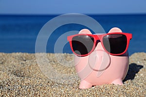 Summer piggy bank on the beach