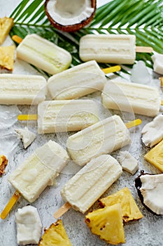 Summer popsicles on stick. Pinacolada flavour. Made with pineapple, cocount milk, rum. Vegan snack