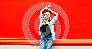 Summer portrait of beautiful blonde young woman wearing sunglasses, shirt in the city