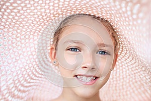 Summer portrait of a beautiful girl in a pink hat.