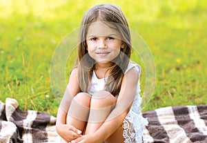 Summer portrait cute little girl on the plaid