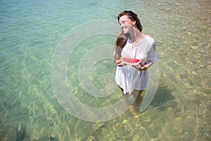Summer portrait of fashion of the surprising healthy woman posing before the blue ocean on the tropical hot exotic island, ho