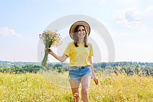 Summer portrait of happy 30s woman with bouquet of wildflowers