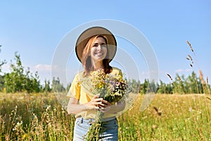 Summer portrait of happy 30s woman with bouquet of wildflowers