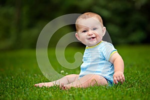 Summer portrait of happy baby boy infant outdoors