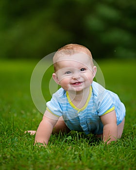 Summer portrait of happy baby boy infant outdoors