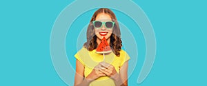 Summer portrait of happy smiling young woman with fresh juicy fruits, lollipop or ice cream shaped slice of watermelon on blue