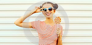 Summer portrait happy smiling young woman with lollipop on white background
