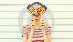 Summer portrait happy smiling young woman with lollipop on white background