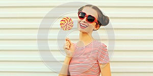 Summer portrait happy smiling young woman with lollipop on white background