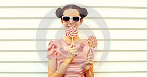 Summer portrait happy smiling young woman with lollipop on white background