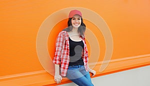 Summer portrait of happy smiling young woman posing in red baseball cap, casual clothes