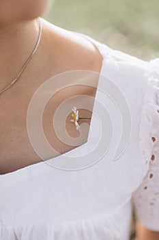 summer portrait. little chamomile flower on a young woman shoulder photo