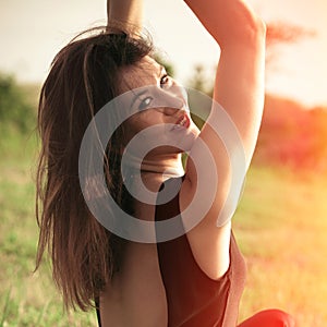 Summer portrait of smiling young woman outdoor shot summer day at grass field