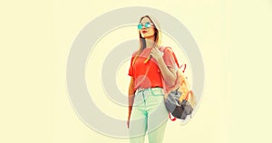 Summer portrait of stylish blonde young woman wearing backpack, sunglasses in the city