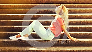 Summer portrait of stylish blonde young woman wearing sunglasses in the city