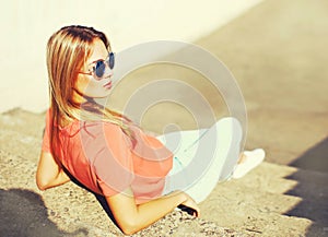 Summer portrait of stylish blonde young woman wearing sunglasses in the city
