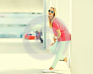 Summer portrait of stylish blonde young woman wearing sunglasses in the city