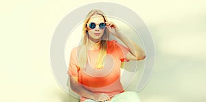 Summer portrait of stylish blonde young woman wearing sunglasses in the city