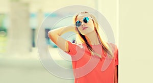 Summer portrait of stylish blonde young woman wearing sunglasses in the city