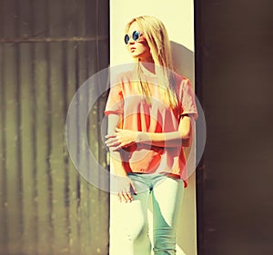 Summer portrait of stylish blonde young woman wearing sunglasses in the city