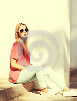 Summer portrait of stylish blonde young woman wearing sunglasses in the city