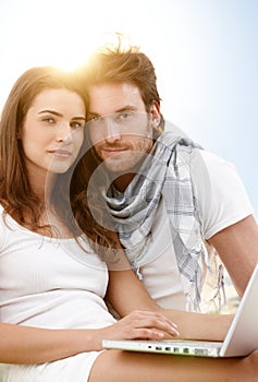 Summer portrait with young couple with laptop