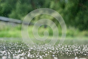 Summer rain splashes down the road.