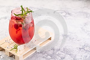 Summer refreshing cocktails made of rose wine or gin with raspberries and rosemary