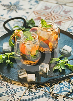 Summer refreshing cold peach ice tea with fresh mint