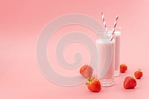 Summer refreshing desserts and calcium rich healthy drink concept theme with glasses of strawberry milk, striped straws and