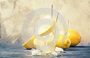 Summer refreshing drink, cold sparkling water with ice and lemon