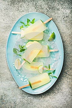 Summer refreshing lemonade popsicles with lime and chipped ice