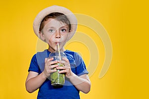 Summer refreshment. Cold beverage. Little boy with plastic cup of fresh lemonade