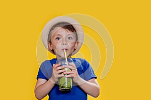 Summer refreshment. Cold beverage. Little boy with plastic cup of fresh lemonade