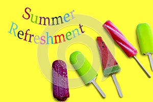 Summer refreshment with colorful letters and five ice cream on the yellow surface.