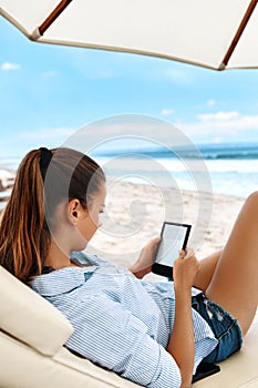 Summer Relaxation. Woman Reading, Relaxing On Beach. Summertime