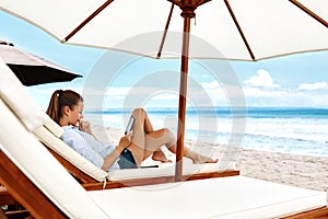 Summer Relaxation. Woman Reading, Relaxing On Beach. Summertime