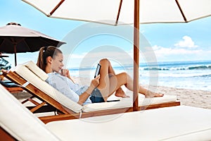 Summer Relaxation. Woman Reading, Relaxing On Beach. Summertime photo