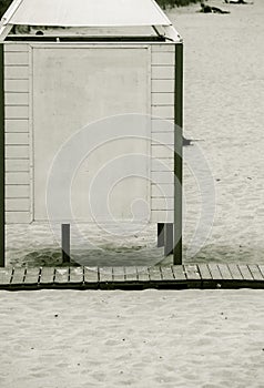 Summer resort. White dressing cabin on a sandy beach.