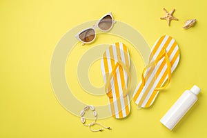 Summer rest concept. Top view photo of yellow striped flip-flops sunglasses sunscreen bottle shell bracelet and starfish on