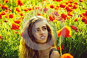 Summer rest. Fashionable woman posing. woman or happy girl in field of poppy seed