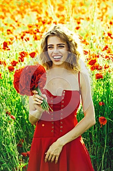 Summer rest. Fashionable woman posing. pretty woman or happy girl in field of poppy seed