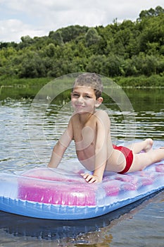 In the summer on the river on an inflatable mattress funny littl