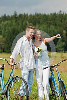 Summer - Romantic couple with bike in meadow