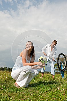 Summer - Romantic couple with bike in meadow