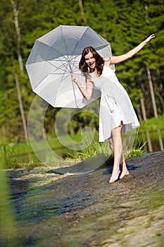 Summer - romantic woman with parasol in sunlight