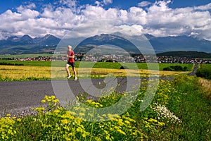 Summer running training. Long distance runner train in summer landscape