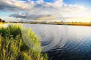 Summer rural landscape with Szkarpawa river at sunset.