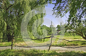 Summer russian country landscape with old church in sunny day